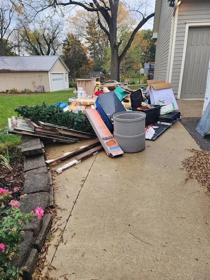 Dumpster being loaded with debris for Estate Cleanout Dumpster Rental in Ellisburg